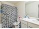 The full bathroom is equipped with a toilet, a vanity, and a shower-tub with curtain at 3541 Condor Ct, Atlanta, GA 30331