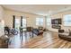 Spacious living room area with wood-style flooring, a ceiling fan, and a view of the backyard at 3541 Condor Ct, Atlanta, GA 30331