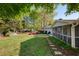 Serene backyard oasis with stepping stones, a covered porch, and vibrant azaleas in full bloom at 5132 Foxwood Ct, Atlanta, GA 30360