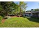 Expansive backyard with mature trees, flowering bushes, and lush lawn at 5132 Foxwood Ct, Atlanta, GA 30360