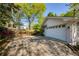 Attached garage with ample parking and a beautiful garden bed in front of the wooden fence at 5132 Foxwood Ct, Atlanta, GA 30360