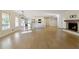 Open-concept living space with hardwood floors, brick fireplace, and a seamless flow into the modern kitchen at 5132 Foxwood Ct, Atlanta, GA 30360