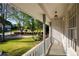 Covered front porch featuring views of the lawn and surrounding landscape with crisp white columns and railings at 5132 Foxwood Ct, Atlanta, GA 30360