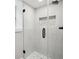 Tiled walk-in shower with glass door, and integrated shelving at 878 Dill Sw Ave, Atlanta, GA 30310
