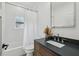 Bright bathroom featuring white tile, dark stone countertop, and modern fixtures at 878 Dill Sw Ave, Atlanta, GA 30310