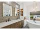 Elegant bathroom with dual vanities, soaking tub, patterned wallpaper, and modern fixtures at 878 Dill Sw Ave, Atlanta, GA 30310