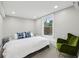 Bright bedroom with window, plush carpet, and cozy armchair at 878 Dill Sw Ave, Atlanta, GA 30310