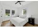 This bedroom offers a ceiling fan, hardwood floors, and bright window views at 878 Dill Sw Ave, Atlanta, GA 30310