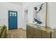 Entryway features hardwood floors, blue door, and stylish accent table with modern art at 878 Dill Sw Ave, Atlanta, GA 30310