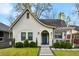 Charming, renovated home features a blue door, crisp white brick, a landscaped yard, and inviting curb appeal at 878 Dill Sw Ave, Atlanta, GA 30310