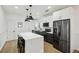 Modern kitchen featuring stainless steel appliances, white cabinets, a marble countertop island, and hardwood floors at 878 Dill Sw Ave, Atlanta, GA 30310
