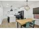 Open kitchen with island seating, stainless appliances, and black pendant lighting fixtures at 878 Dill Sw Ave, Atlanta, GA 30310