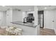 Open concept kitchen with stainless steel appliances and breakfast bar seating at 878 Dill Sw Ave, Atlanta, GA 30310