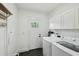 An organized laundry room with washer, dryer, and storage cabinets at 878 Dill Sw Ave, Atlanta, GA 30310