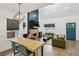 Open concept living room with dining area features modern fireplace and large windows at 878 Dill Sw Ave, Atlanta, GA 30310