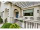 Close-up of a front porch with a blue door, pergola, and comfortable seating area at 878 Dill Sw Ave, Atlanta, GA 30310