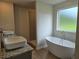Bright bathroom featuring double vanities, soaking tub, and tiled shower at 1594 Sungrown Way, Mcdonough, GA 30253