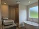 Bright bathroom featuring double vanities, soaking tub, and tiled shower at 1594 Sungrown Way, Mcdonough, GA 30253