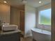 Bathroom with free-standing tub, stone countertop and sink at 1594 Sungrown Way, Mcdonough, GA 30253