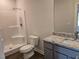 Bathroom featuring a shower, toilet, and granite vanity with sink at 1594 Sungrown Way, Mcdonough, GA 30253