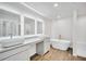 Bright bathroom featuring double sink vanities, a modern bathtub, and elegant tile flooring at 1594 Sungrown Way, Mcdonough, GA 30253