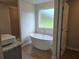 Bright bathroom featuring double vanities, soaking tub, and tiled shower at 1594 Sungrown Way, Mcdonough, GA 30253