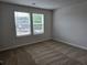 Bright bedroom with neutral carpet and two windows for ample natural light at 1594 Sungrown Way, Mcdonough, GA 30253