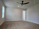 Large, carpeted bedroom with ceiling fan and adjacent bathroom at 1594 Sungrown Way, Mcdonough, GA 30253