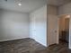Bedroom featuring wood-look flooring, neutral walls, closet, and a view into the ensuite bath at 1594 Sungrown Way, Mcdonough, GA 30253