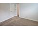 Carpeted bedroom with white doors, trim, and neutral walls at 1594 Sungrown Way, Mcdonough, GA 30253