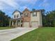 Two-story home featuring a brick and vinyl exterior, a two-car garage, and a well-manicured front lawn at 1594 Sungrown Way, Mcdonough, GA 30253