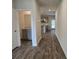 Hallway featuring wood-look flooring with a view of the bathroom and kitchen at 1594 Sungrown Way, Mcdonough, GA 30253