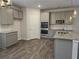Well-lit kitchen features stainless appliances and light gray cabinets with granite countertops at 1594 Sungrown Way, Mcdonough, GA 30253