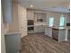 Open-concept kitchen with gray cabinets, granite countertops, stainless appliances and wood flooring at 1594 Sungrown Way, Mcdonough, GA 30253
