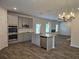 Open-concept kitchen features stainless appliances, granite countertops, and gray cabinets at 1594 Sungrown Way, Mcdonough, GA 30253