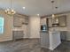Well-lit kitchen features gray cabinetry, granite countertops, stainless appliances and modern pendant lighting at 1594 Sungrown Way, Mcdonough, GA 30253