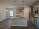 Open-concept kitchen and dining area feature gray cabinetry, granite countertops, and stainless appliances at 1594 Sungrown Way, Mcdonough, GA 30253