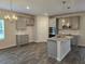 Well-lit kitchen features gray cabinetry, granite countertops, stainless appliances and pendant lighting at 1594 Sungrown Way, Mcdonough, GA 30253