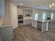 Modern kitchen features stainless appliances, granite countertops, and spacious island with stylish gray cabinetry at 1594 Sungrown Way, Mcdonough, GA 30253