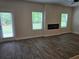 Cozy living room with modern fireplace insert and natural light at 1594 Sungrown Way, Mcdonough, GA 30253