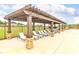 Relaxing poolside lounge area with comfortable seating under a pergola, perfect for sunny days at 1594 Sungrown Way, Mcdonough, GA 30253