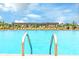 Community swimming pool with inviting blue water, lounge chairs, and a pergola offers residents a refreshing escape at 1595 Sungrown Way, Mcdonough, GA 30253