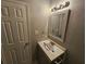 Cozy bathroom vanity with a framed mirror, and a modern sink illuminated by a stylish light fixture at 200 Williamsburg Way, Fayetteville, GA 30214