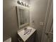 This bathroom features a modern sink, vanity and mirror with decorative lighting at 200 Williamsburg Way, Fayetteville, GA 30214