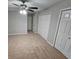 This bedroom has plush carpets, ceiling fan, and a large closet space at 200 Williamsburg Way, Fayetteville, GA 30214