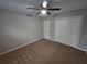 This bedroom has plush carpet, a ceiling fan, and access to a double closet at 200 Williamsburg Way, Fayetteville, GA 30214
