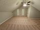 This carpeted bonus room features plenty of space and access to multiple closets at 200 Williamsburg Way, Fayetteville, GA 30214
