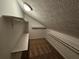 A carpeted attic closet offers extra storage space with shelving and a clothing rod at 200 Williamsburg Way, Fayetteville, GA 30214