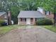 Charming brick home featuring a cozy front porch and a well-maintained yard, perfect for comfortable living at 200 Williamsburg Way, Fayetteville, GA 30214