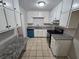 Well-lit kitchen with granite countertops, tiled floors, and ample white cabinetry space for storage and cooking at 200 Williamsburg Way, Fayetteville, GA 30214